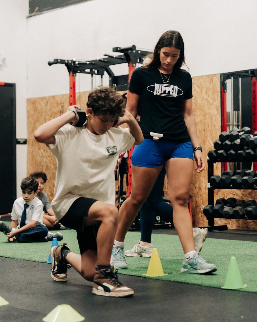 Coach leading kids through lunges